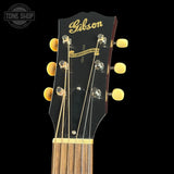 Gibson guitar headstock with brand name on a black background