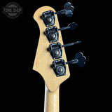 Guitar headstock with tuning pegs on a black background, featuring the Tone Shop logo.