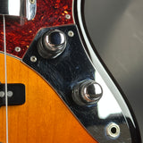 Close-up of a guitar's headstock with tuning pegs and wood finish.