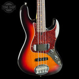 Electric bass guitar with a sunburst finish on a black background, featuring the Tone Shop logo.