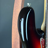 Close-up of a guitar's neck and headstock against a dark background