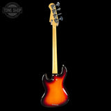 Electric bass guitar with sunburst finish on a black background, featuring the Tone Shop logo.