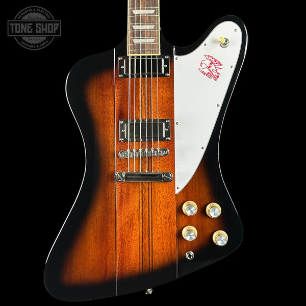 Gibson electric guitar with a sunburst finish on a black background, featuring the Tone Shop logo.