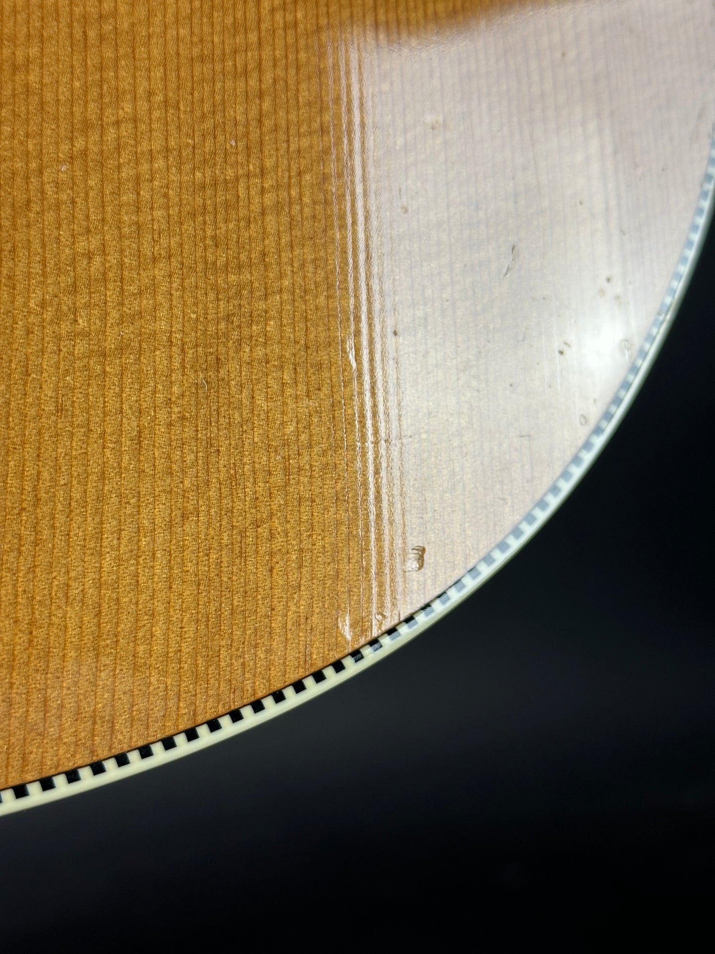 Close-up of a vinyl record with visible grooves on a black background