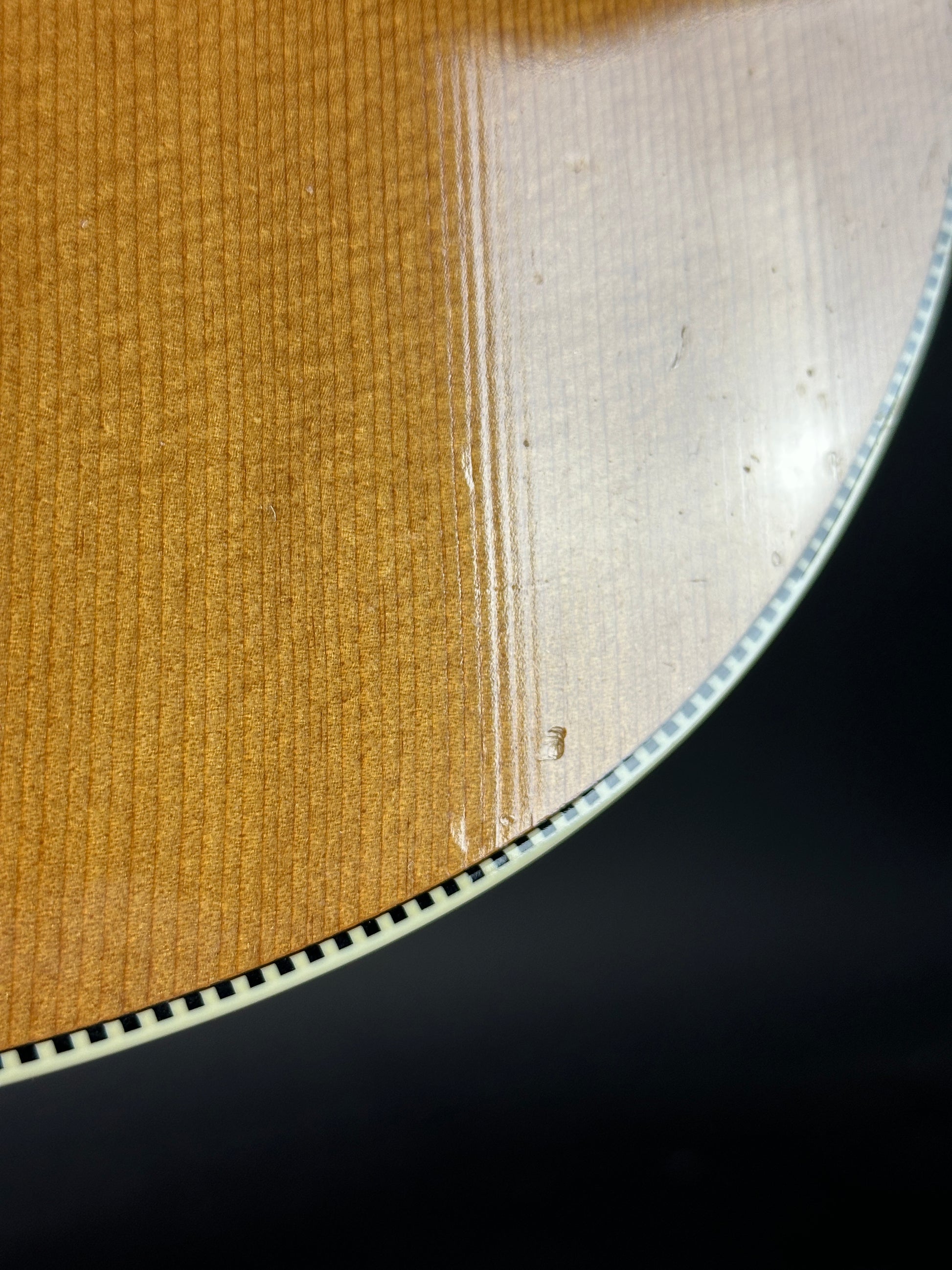 Close-up of a vinyl record with visible grooves on a black background