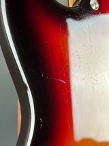 Close-up of a guitar's neck with a scratch on the fretboard
