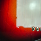 Close-up of a red surface with a white area and metal screws.