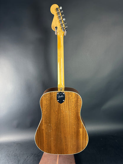 Wooden acoustic guitar on a gray background
