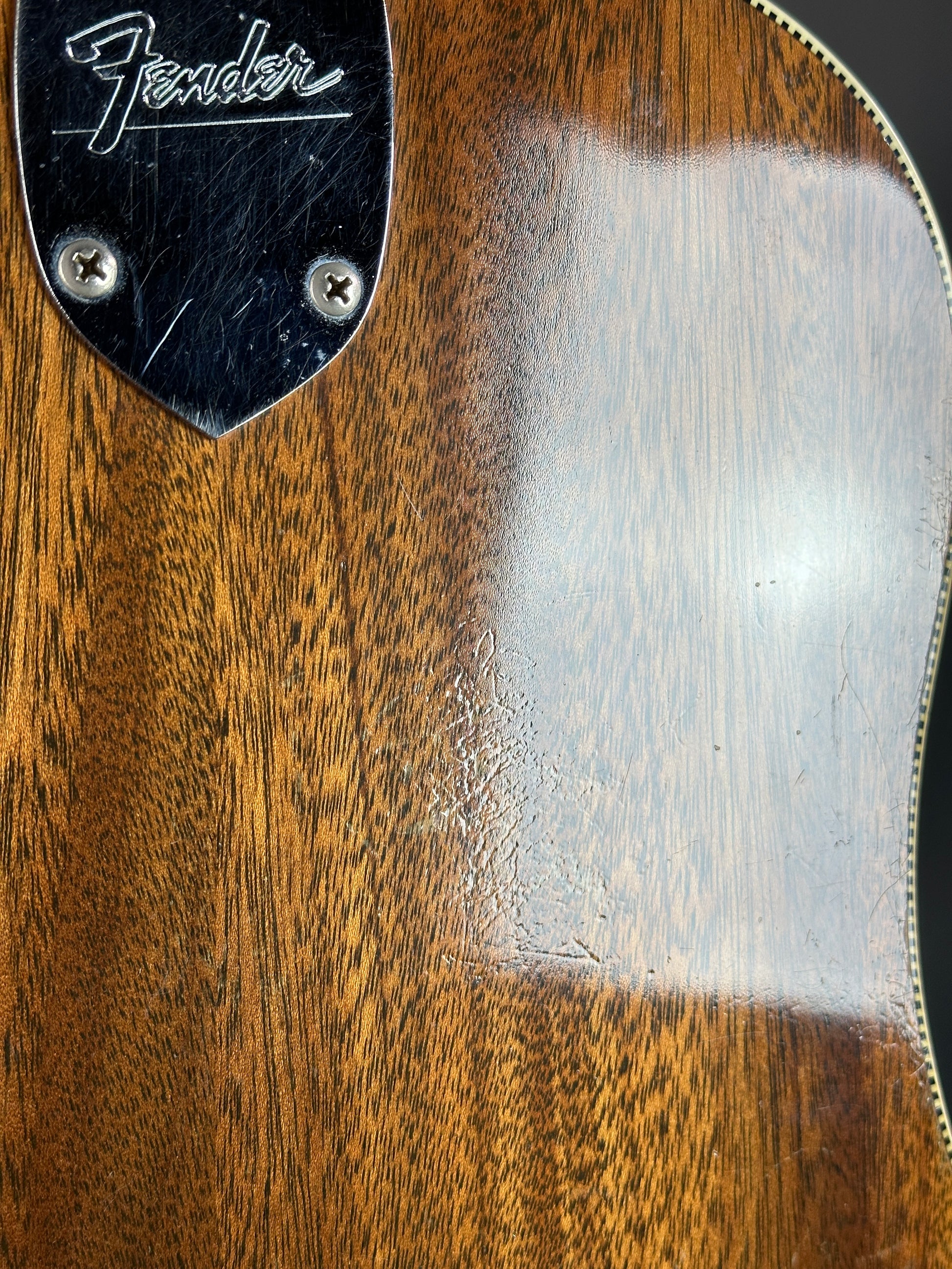 Close-up of a Fender guitar with wood finish