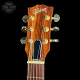 Gibson guitar headstock with brand logo on a black background