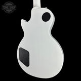 The back view of a white electric guitar body, likely a Gibson Les Paul style, shown against a solid black background with a Tone Shop watermark in the upper left corner.
