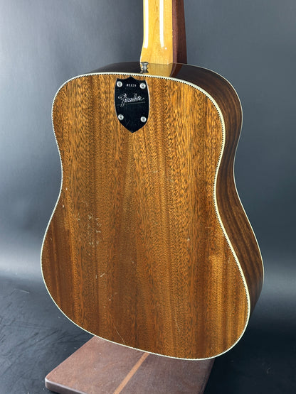 Acoustic guitar with a wooden finish on a gray background