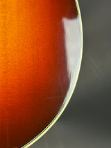 Close-up of a guitar's wooden finish with a dark background