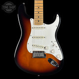 A classic electric guitar with a sunburst finish, featuring a white pickguard, chrome hardware, and a maple neck, shown against a solid black background.