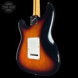 Fender Stratocaster electric guitar body in a classic sunburst finish, showing the transition from amber-orange to black, with a white pickguard and maple neck visible against a black background.