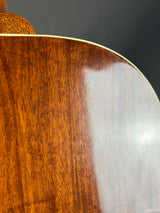 Close-up of a wooden guitar with a dark gray background