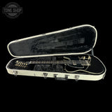 Guitar in a white case on a black background with 'Tone Shop' logo.