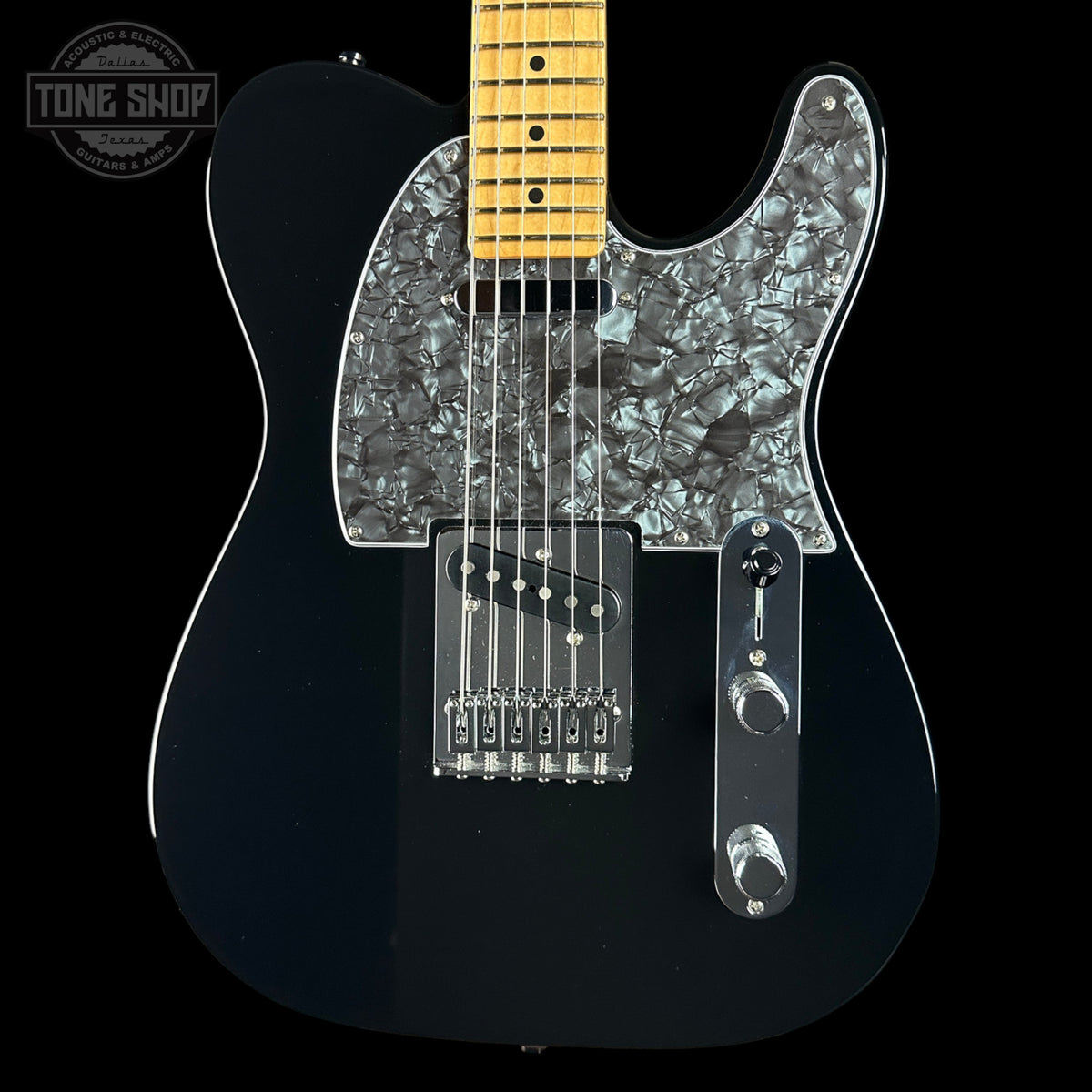 A black electric guitar with a glossy black body, a silver mother-of-pearl pickguard, and a natural maple neck, shown against a solid black background.