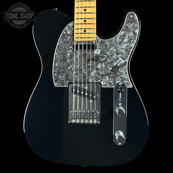 A black electric guitar with a glossy black body, a silver mother-of-pearl pickguard, and a natural maple neck, shown against a solid black background.