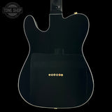 Back view of a black electric guitar with 'Tone Shop' logo in the corner.