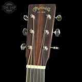 Guitar headstock with Martin & Co logo on a black background
