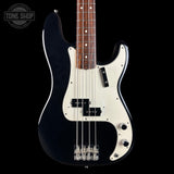 A black and white electric bass guitar with a dark wood fretboard, shown from the front against a black background. A Tone Shop watermark is visible in the top-left corner.