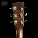 Close-up of a guitar headstock with tuning pegs on a black background, featuring the Tone Shop logo.