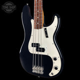 A classic four-string bass guitar with a glossy black body, a white pickguard, and a dark wood fretboard, shown against a solid black background with a Tone Shop watermark in the top left corner.