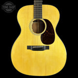 Acoustic guitar with a visible brand logo on a black background