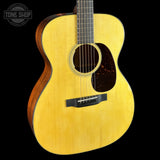 Acoustic guitar with a visible brand logo on a black background