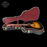 Acoustic guitar in a case with 'Tone Shop' logo in the corner
