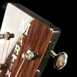 Close-up of a Martin guitar headstock with tuning pegs.