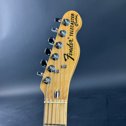 Fender Telecaster guitar headstock on a dark blue background