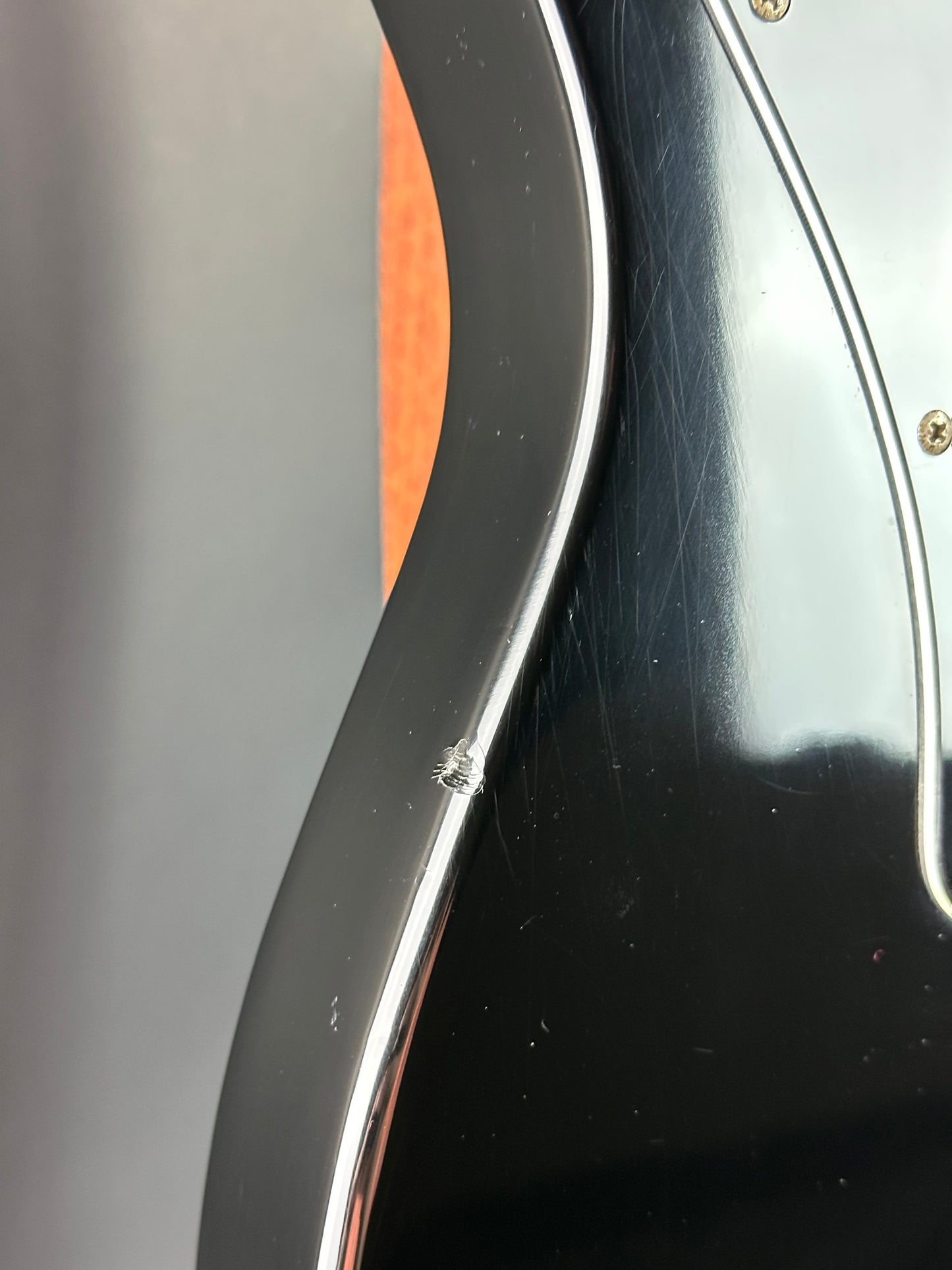 Close-up of a guitar's headstock with tuning pegs and part of the neck.