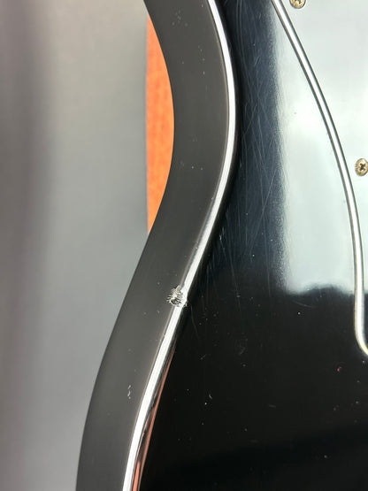 Close-up of a guitar's headstock with tuning pegs and part of the neck.