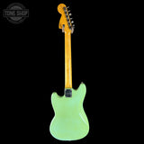 Green electric guitar with a black background