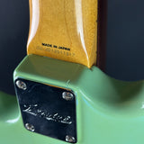 Close-up of a guitar with 'Made in Japan' label and Fender logo.