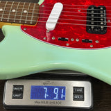 Guitar on a digital scale displaying weight