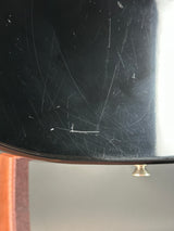 Scratched black surface with a gold handle on a gray background