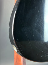 Scratched black surface with a metallic button on a blurred background