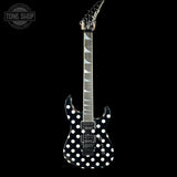 A black electric guitar with white polka dots on the body, shown against a solid black background. The brand logo on the headstock is illegible, and there is a 'TONE SHOP' watermark in the top-left corner.