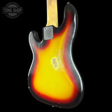 A classic electric guitar body, likely a Fender Strat-style cutaway, featuring a sunburst finish with a bright yellow center fading to orange and red, and a black outer edge. The neck is light wood, and a metal plate is visible near the headstock.