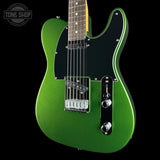 A green electric guitar with a black pickguard and chrome hardware, shown against a black background with a Tone Shop watermark in the top left corner.