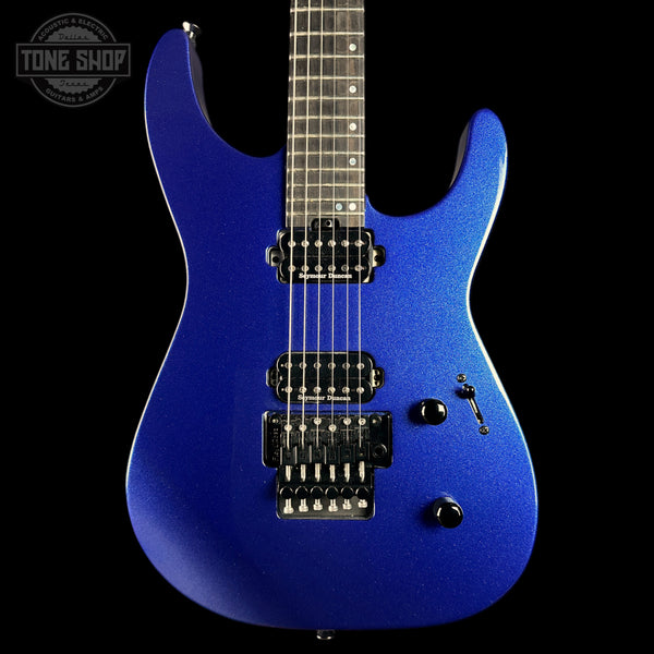 A blue metallic electric guitar with black hardware, shown from the front against a solid black background. A Tone Shop watermark is visible in the top-left corner.