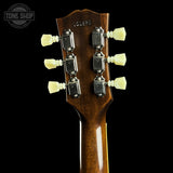 Close-up of the headstock of a guitar against a black background, showing six cream-colored tuning pegs, silver tuning machines, and the brand name 'LS6335' printed on the wood. A Tone Shop watermark is visible in the top left corner.