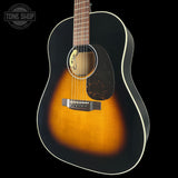 Acoustic guitar with a sunburst finish on a black background, featuring the Tone Shop logo.