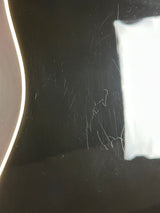 Scratched black surface with white tape on top