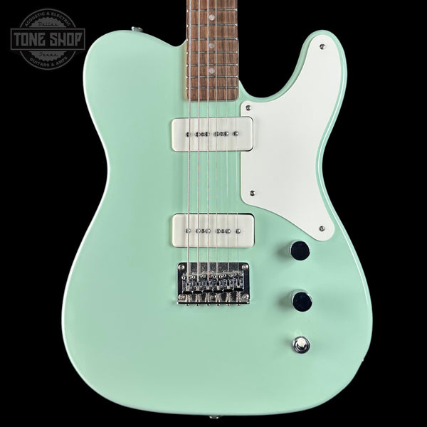 Electric guitar with a seafoam green body on a black background, featuring 'Tone Shop' branding.