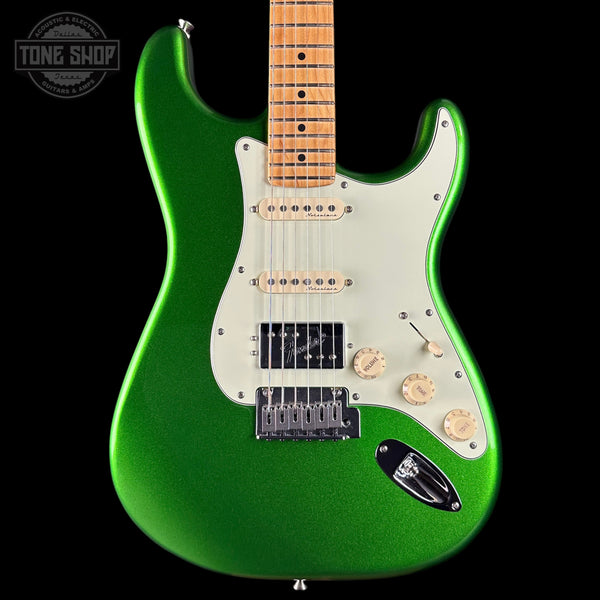 Green electric guitar with a black background