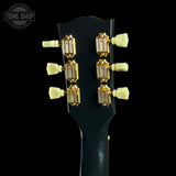 Guitar headstock with tuning pegs on a black background, featuring the Tone Shop logo.